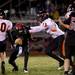 Milan senior quarterback Justin Acecves is sacked by Tecumseh junior defender Chris Dorobantu on Friday. Daniel Brenner I AnnArbor.com